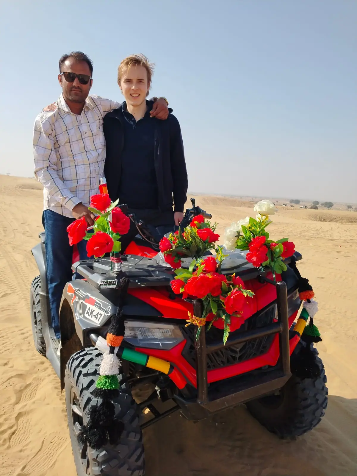 Guests with a decorated quad bike on the dunes