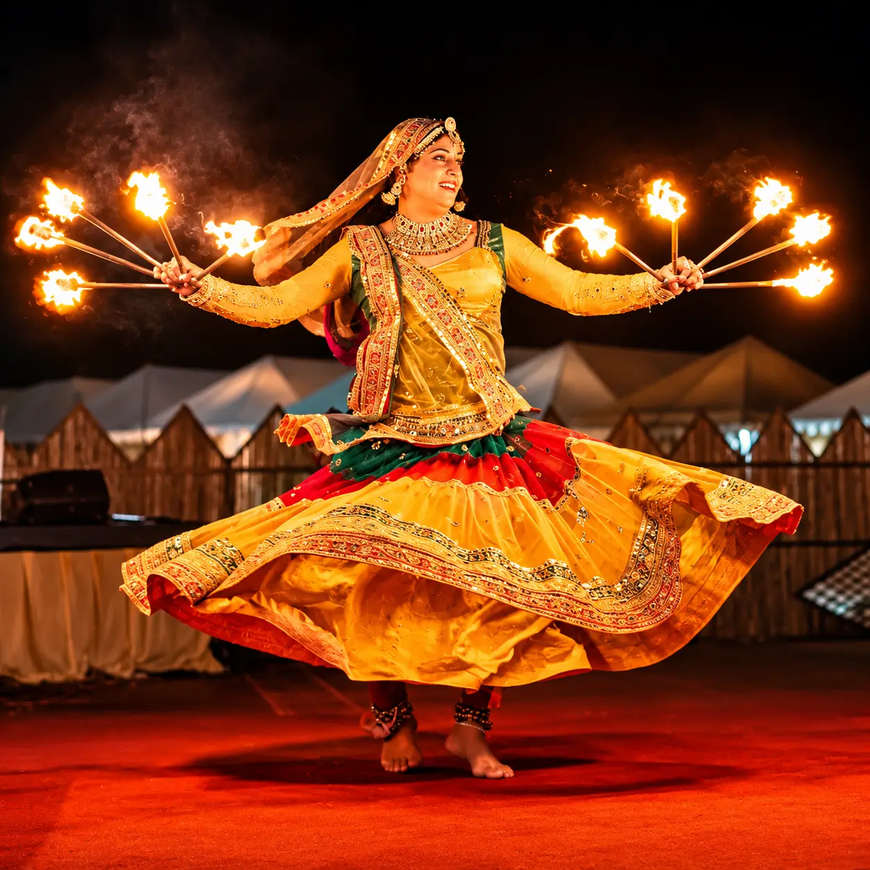 Rajasthani folk dancer performing with fire at a desert camp