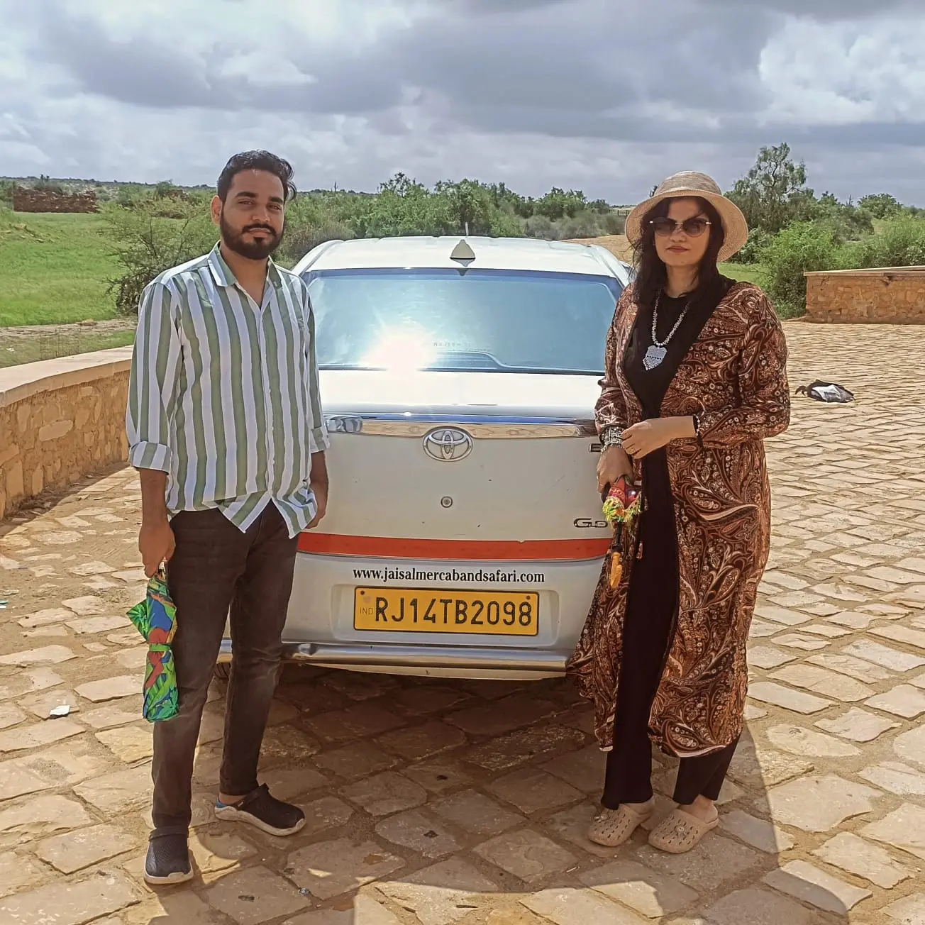 Couple with their taxi before a day tour