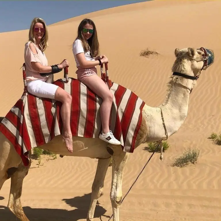 Travellers on a camel safari on the Jaisalmer sand dunes