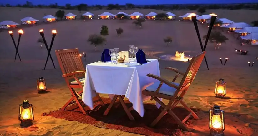 Candle-lit dinner setup in the desert